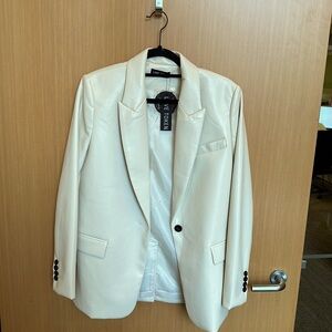 Faux leather oversized cream blazer by Love Token. Black button detail.